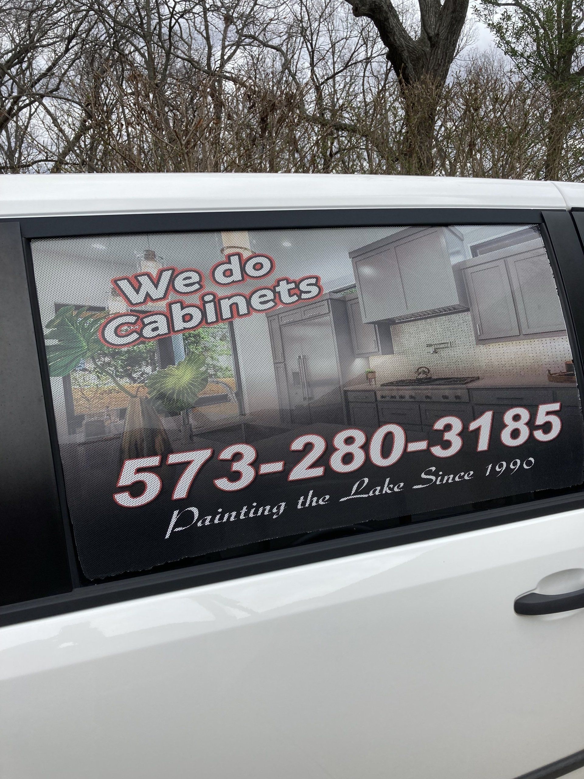 White van door with a spider web repair ad and phone number 573-280-3185