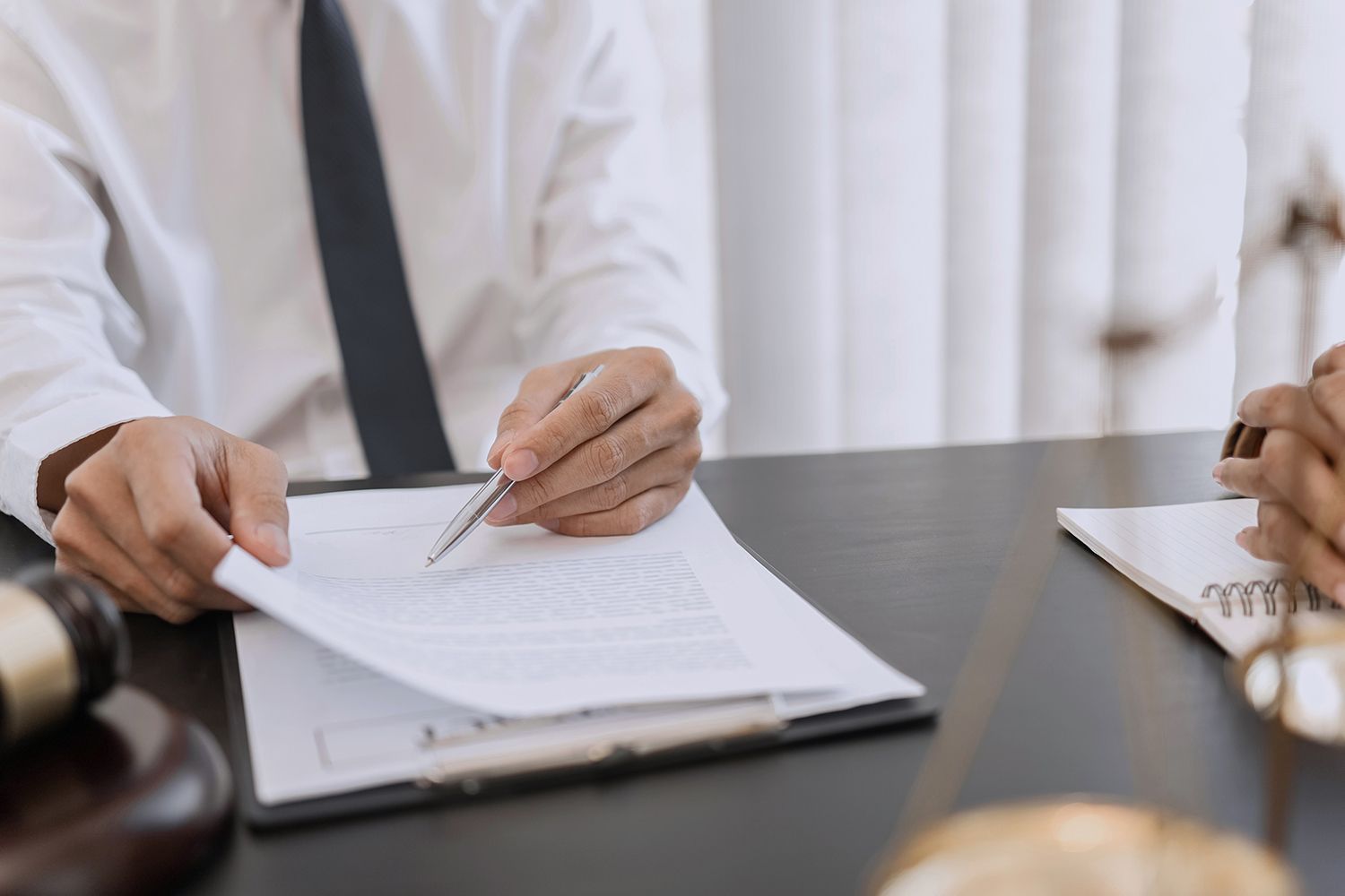 A lawyer is going over a document.