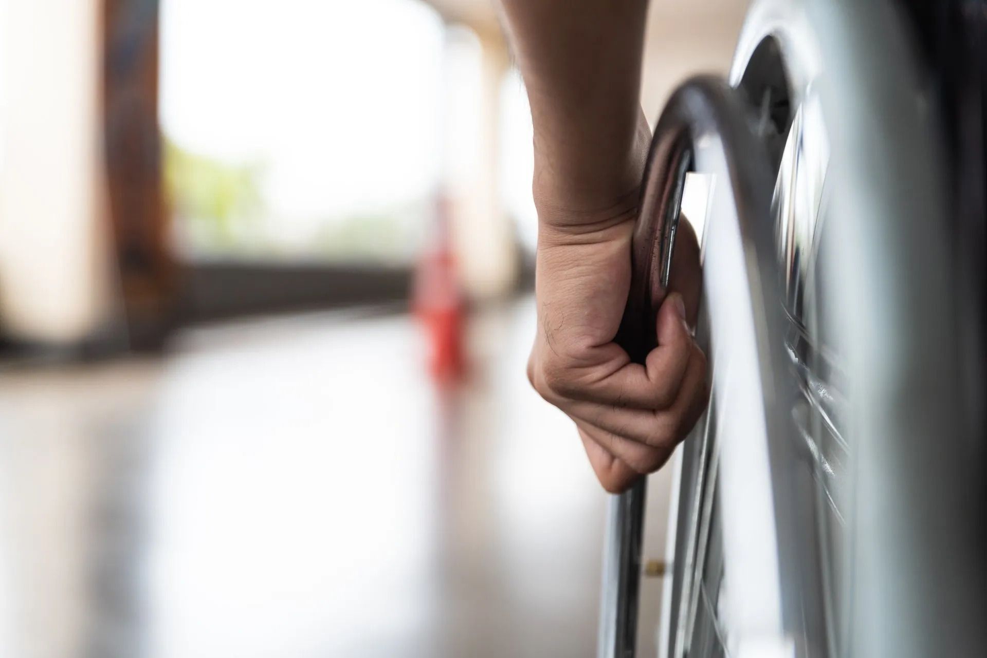hand on wheels of wheelchair