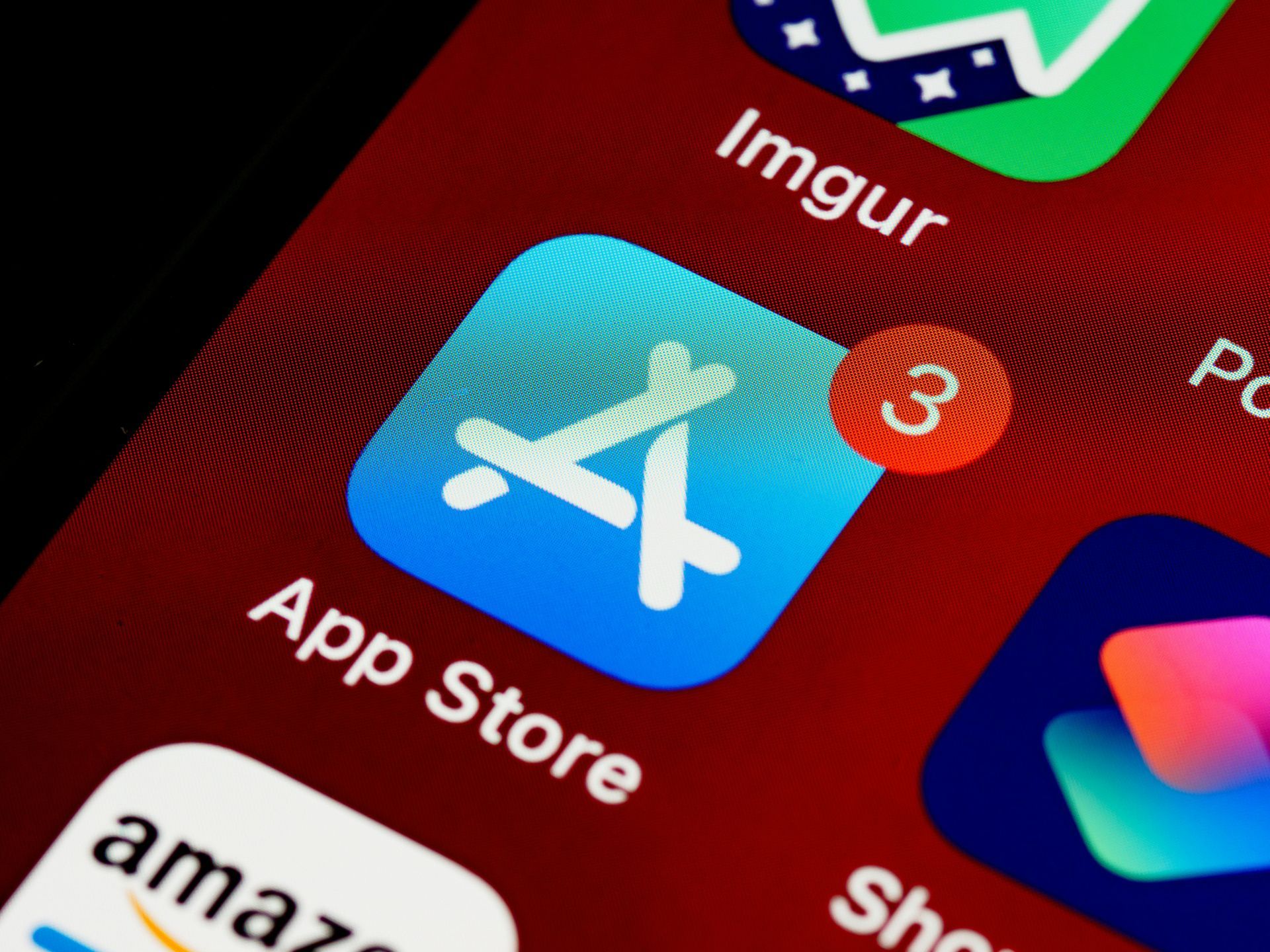 Close-up of a smartphone home screen with the App Store icon showing a 3 notification badge.