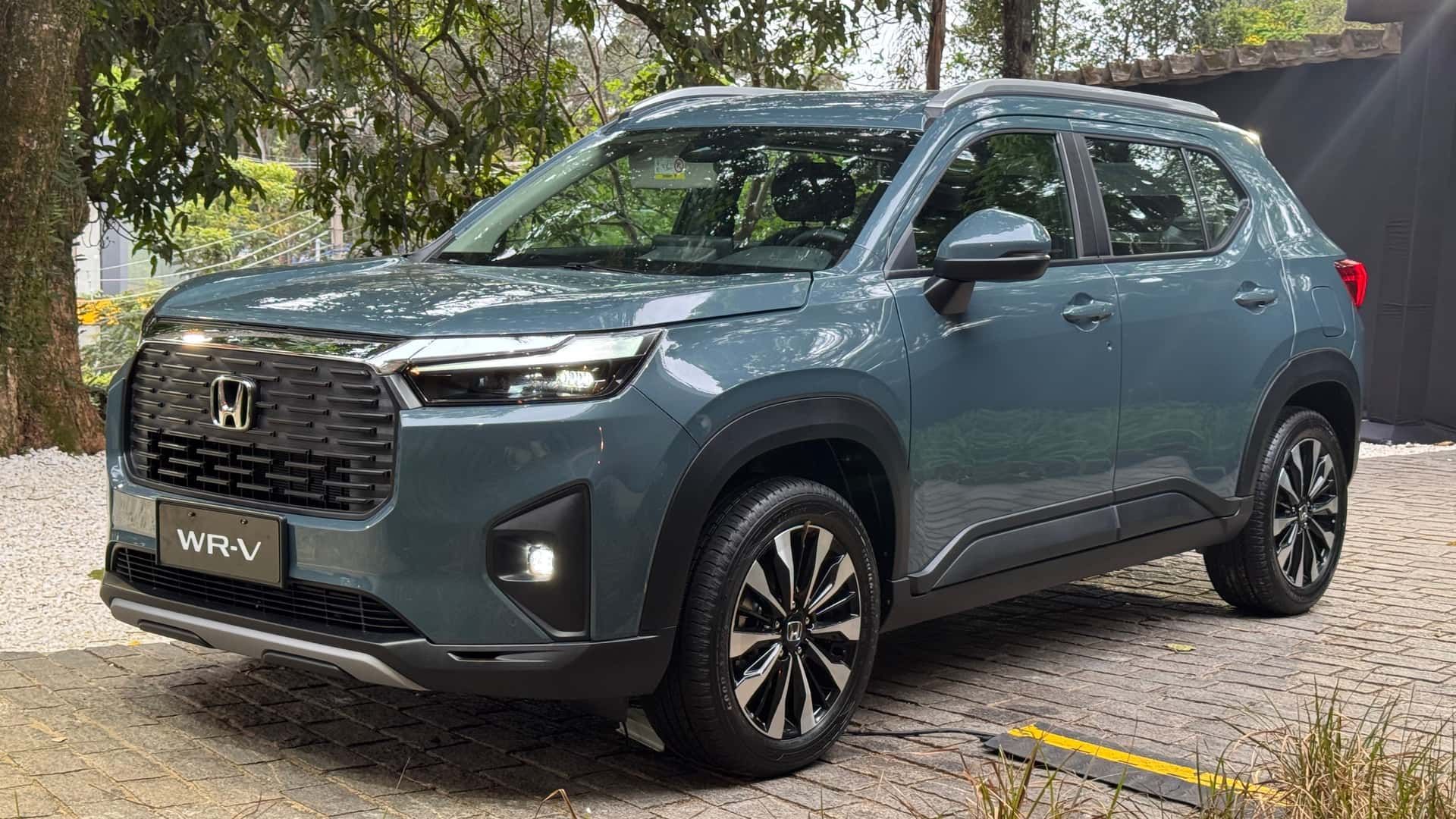Gray Honda SUV parked outdoors on a gravel lot under trees
