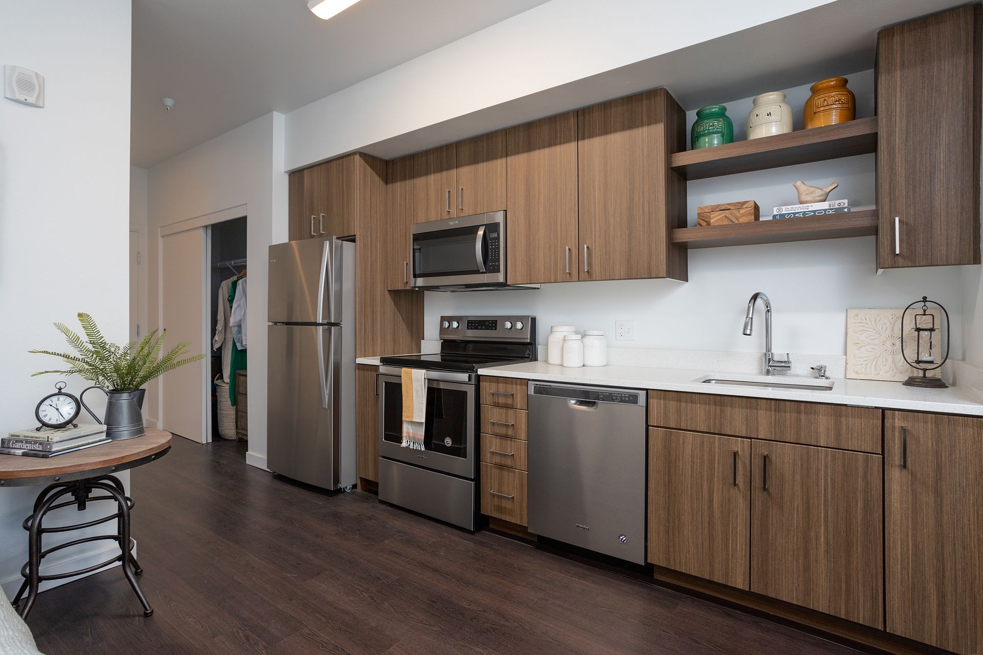 A kitchen with stainless steel appliances and wooden cabinets.