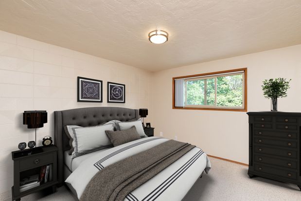 A bedroom with a bed , nightstand , dresser and window.