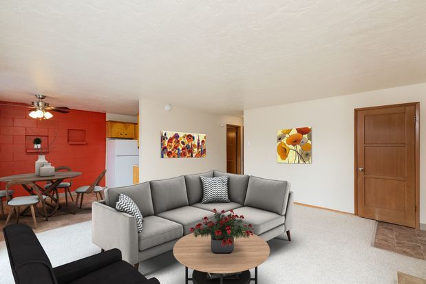 A living room with a couch , chair and fireplace.