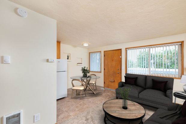 A living room with a sectional couch and a table