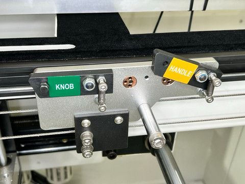 Stops on fence allow to switch between drilling of knobs or handles