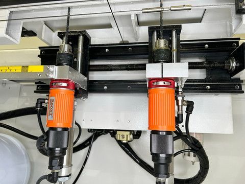 Air drills with adjustable spacing on knob drilling machine