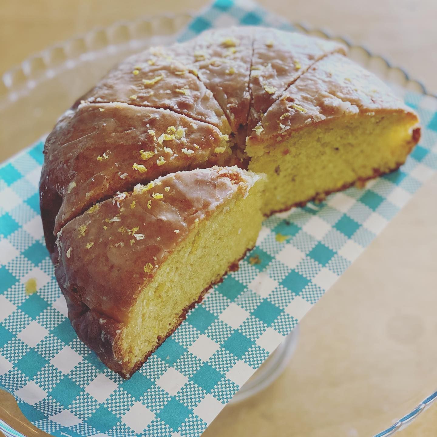 Lemon Cake on Blue and White Checkered Paper, Glazed, Cut Into Slices — Memories Cafe @ Yorkeys Knob in Yorkeys Knob, QLD