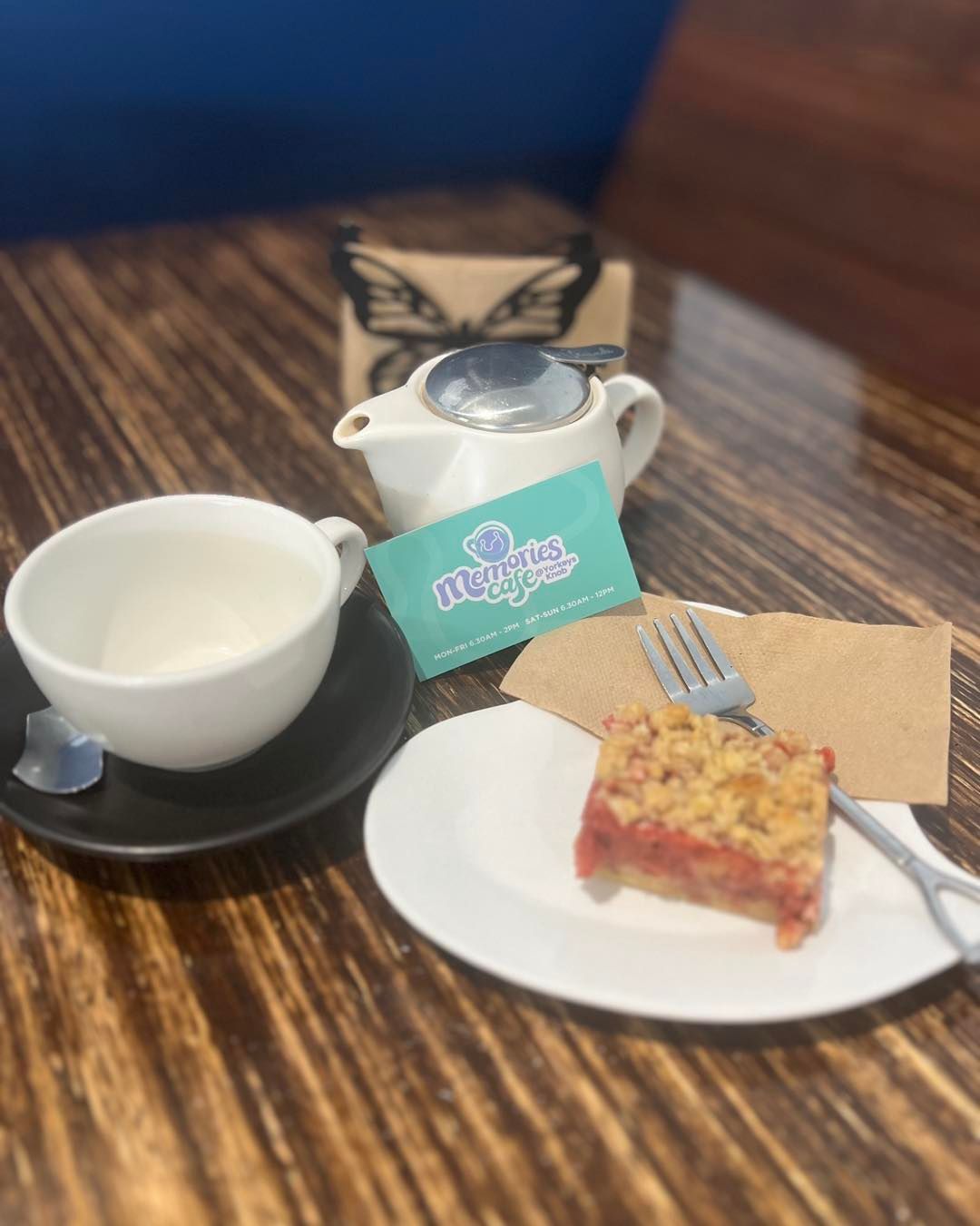 Tea Set With Cake on a Wooden Table — Memories Cafe @ Yorkeys Knob in Yorkeys Knob, QLD