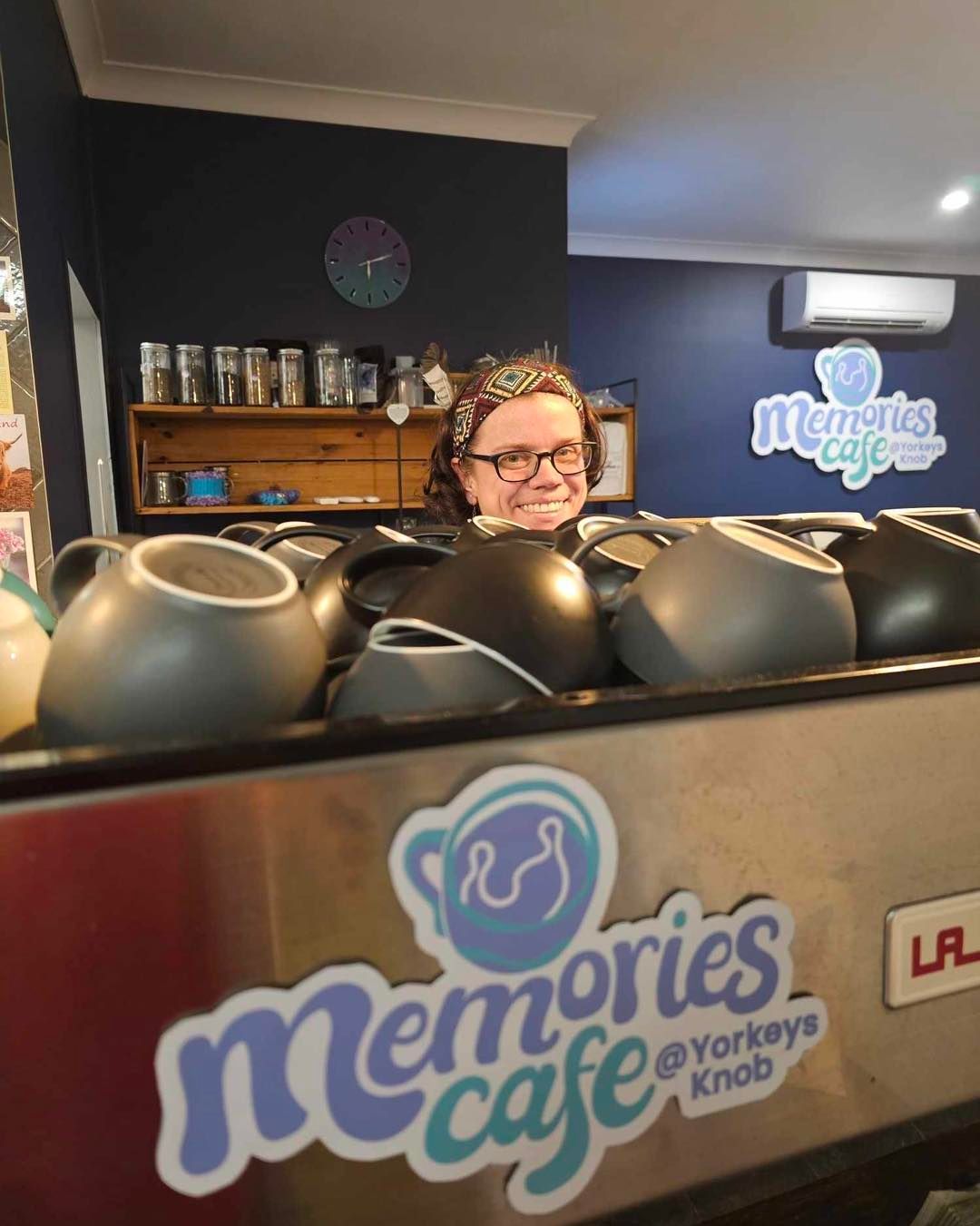 Woman Smiling Behind Coffee Machine — Memories Cafe @ Yorkeys Knob in Yorkeys Knob, QLD