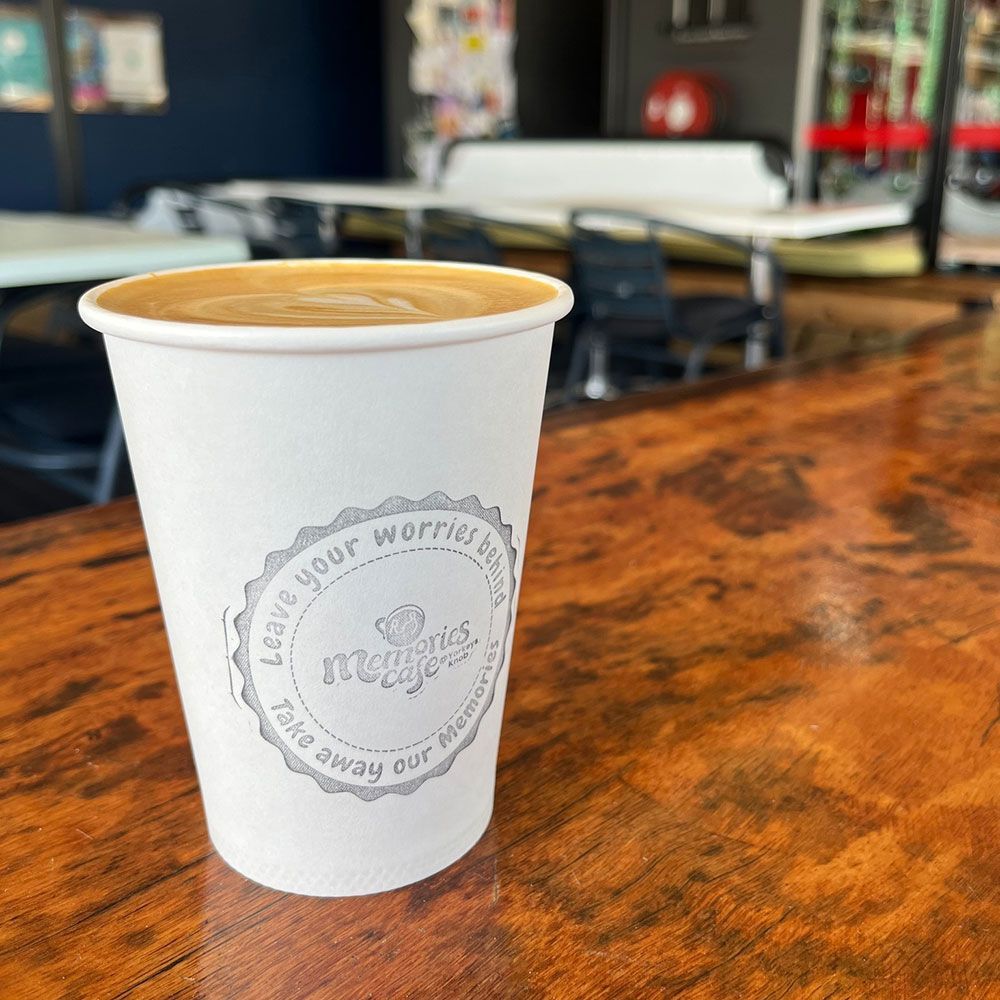 Memories Cafe Coffee is Sitting on a Wooden Table — Memories Cafe @ Yorkeys Knob in Yorkeys Knob, QLD
