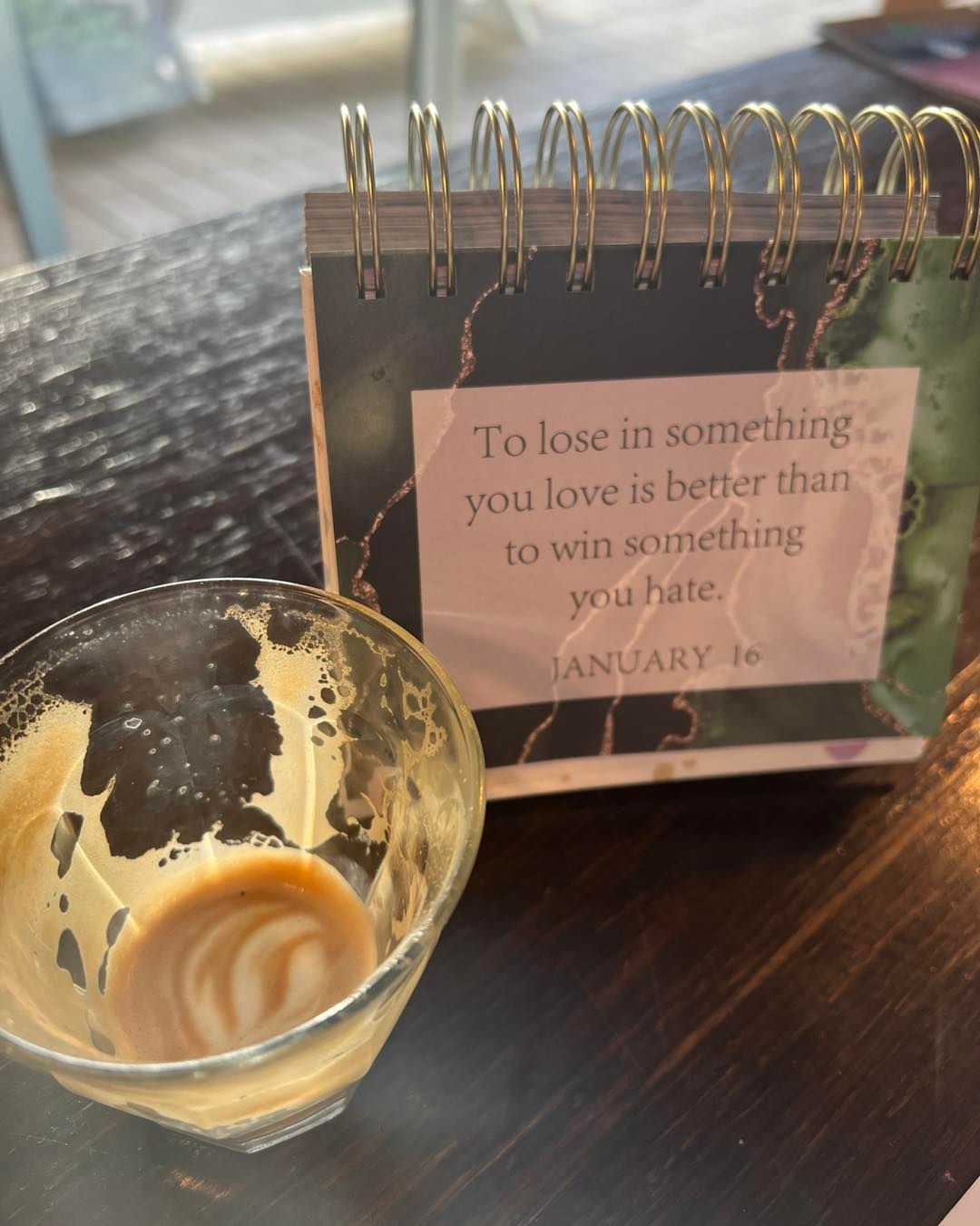 Close-up of a Glass of Coffee Next to a Desk Calendar — Memories Cafe @ Yorkeys Knob in Yorkeys Knob, QLD