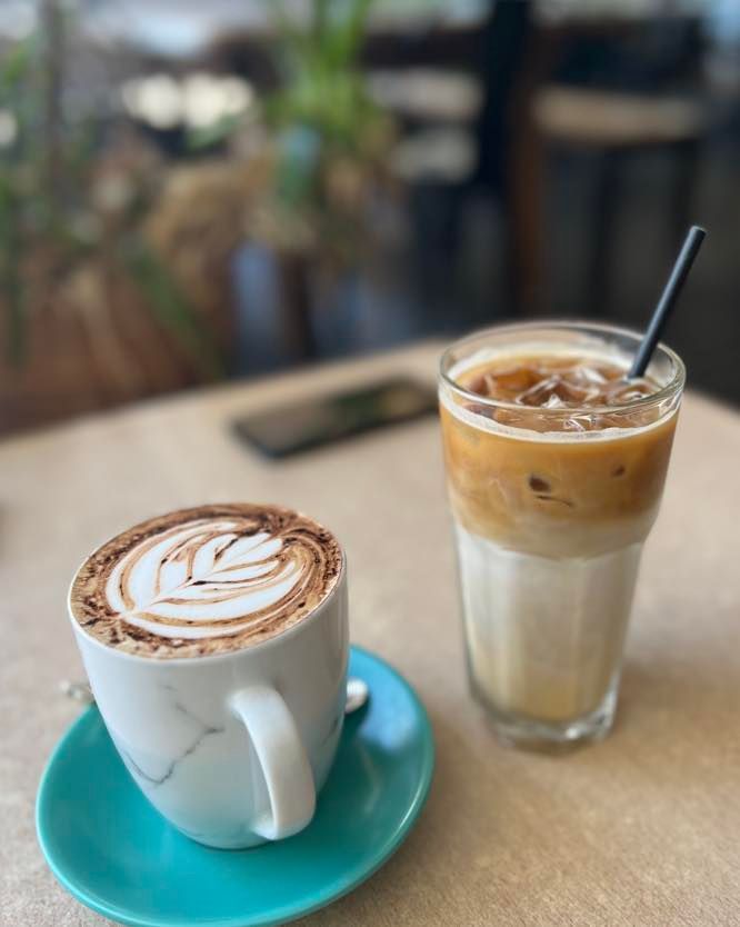 Latte With Art and Iced Latte on a Table in a Cafe — Memories Cafe @ Yorkeys Knob in Yorkeys Knob, QLD