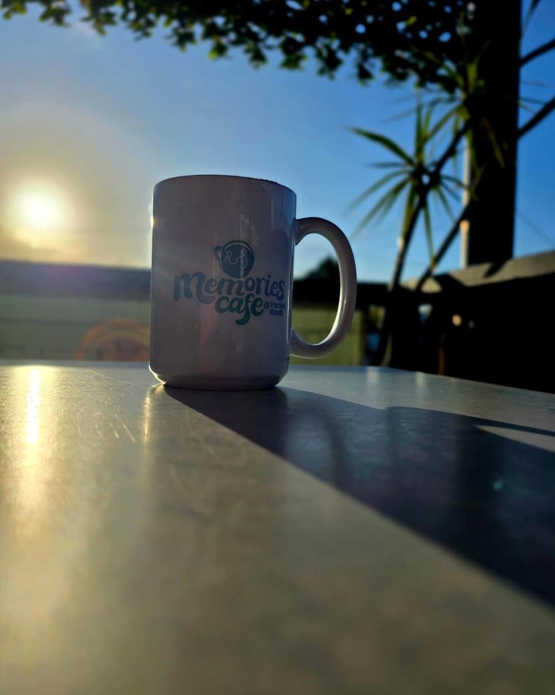 White Mug on a Table at Sunrise — Memories Cafe @ Yorkeys Knob in Yorkeys Knob, QLD