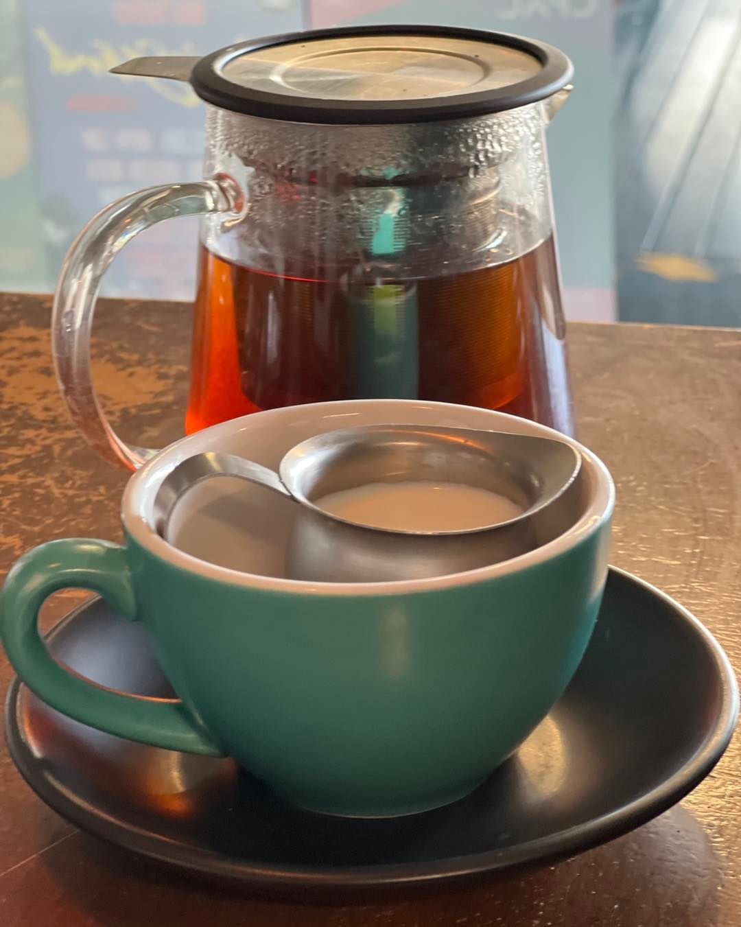 A Glass Teapot of Tea and a Teal Cup With a Metal Strainer Filled — Memories Cafe @ Yorkeys Knob in Yorkeys Knob, QLD
