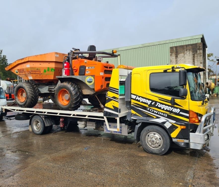 A Dump Truck is Being Towed by a Towing Truck — Wyong and Tuggerah Towing Service in Erina, NSW
