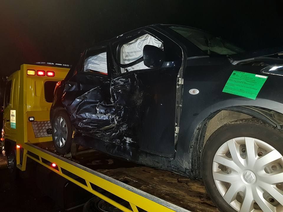 A Black Car is Sitting on Top of a Yellow Tow Truck — Wyong and Tuggerah Towing Service in Woy Woy, NSW