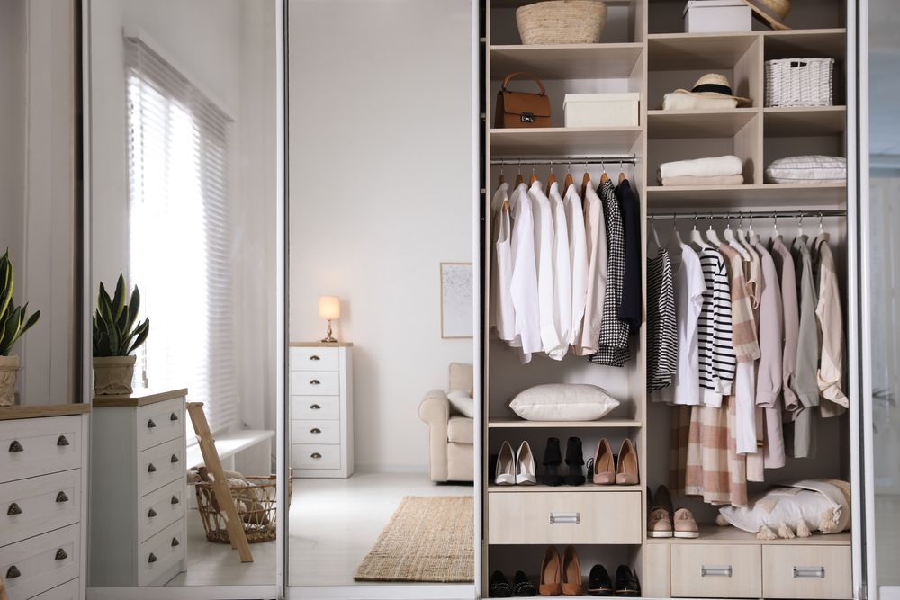 Walk-in Closet With Sliding Mirror Doors, Showing Organized Clothes — Sams Glass Solutions in Proserpine, QLD