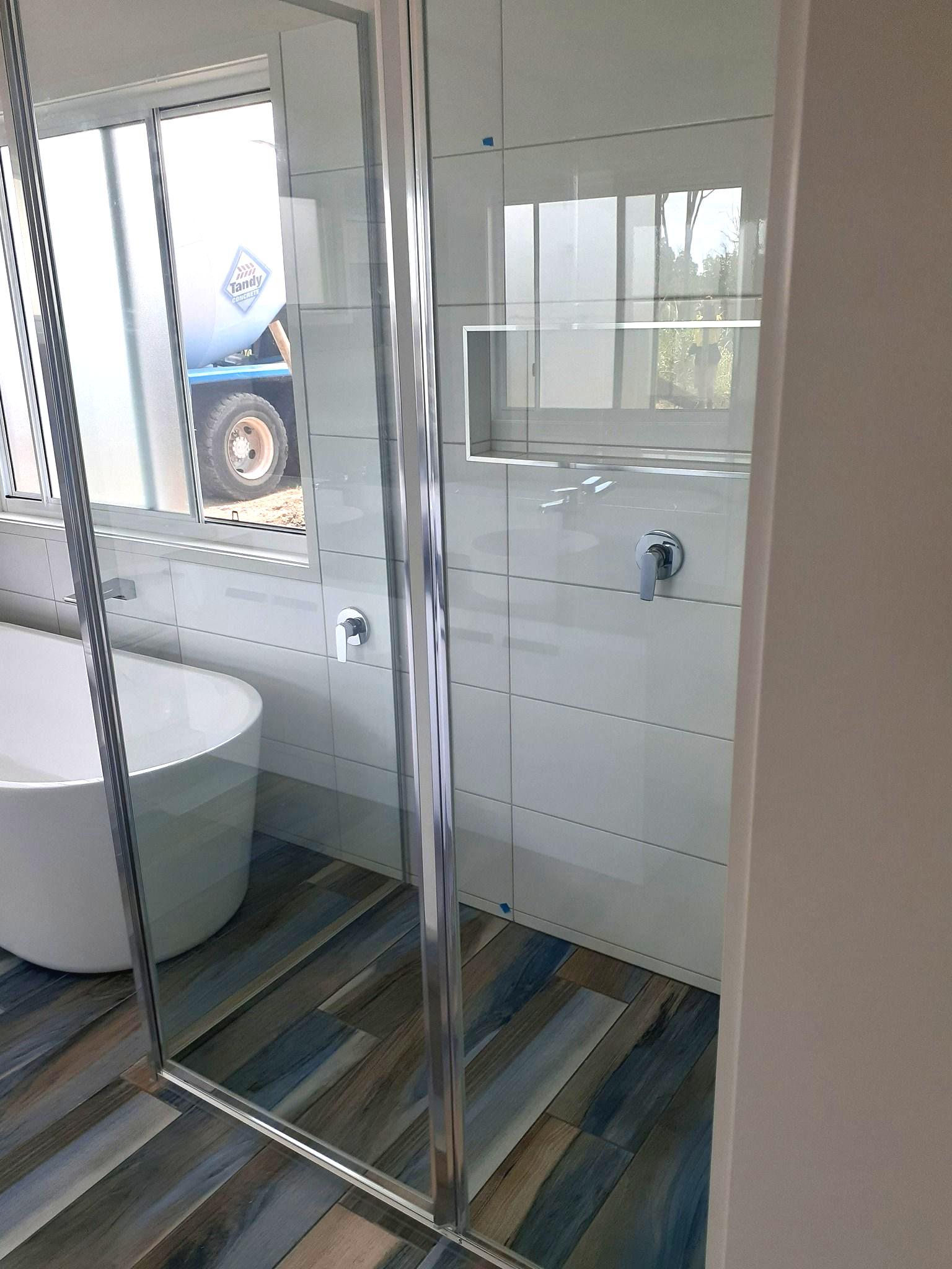 Person Installing Weather Stripping Around a Window Frame — Sams Glass Solutions in Proserpine, QLD