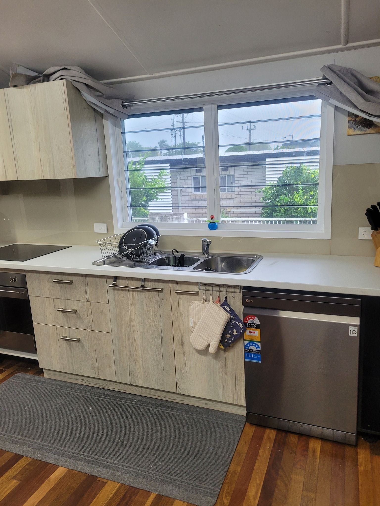 Kitchen Interior With Light Wood Cabinets — Sams Glass Solutions in Proserpine, QLD
