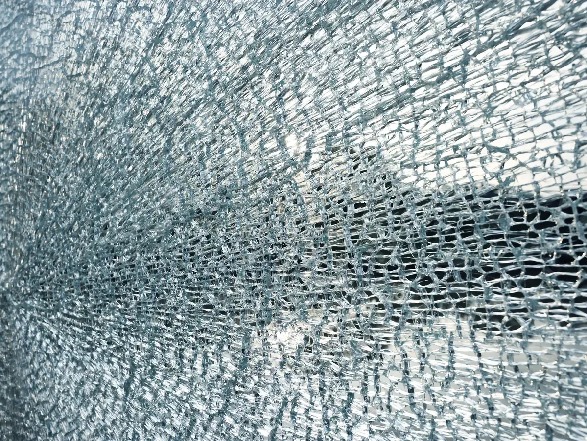 A Close-up of Shattered Safety Glass Showing a Dense — Sams Glass Solutions in Proserpine, QLD