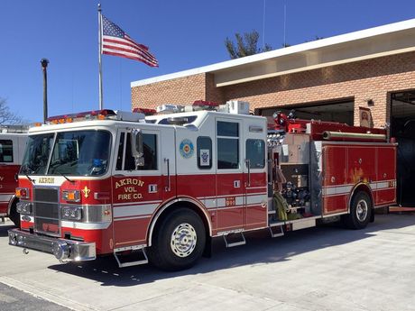 Akron's Rescue Engine 12-1  parked in front of the fire station.