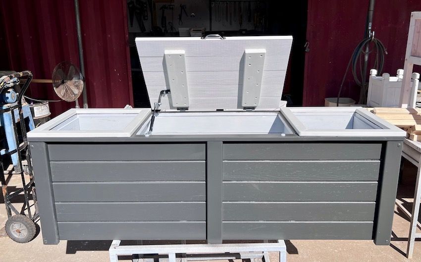 Gray outdoor kitchen cabinet with a white countertop and sink, shown in a workshop or studio setting
