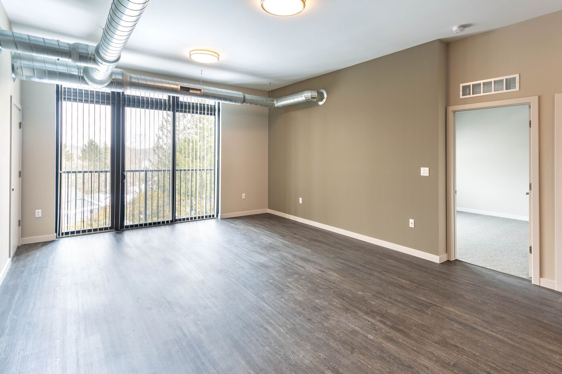The Marquette  - unfurnished living room with Tv and sofa