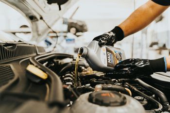 Mechanic Pouring Engine Oil During Vehicle Maintenance Service | True North Automotive