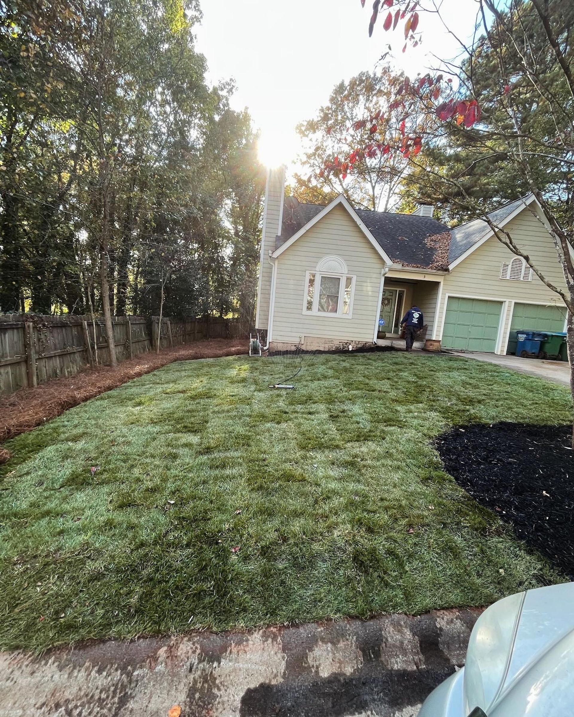 A house with a lush green lawn in front of it.
