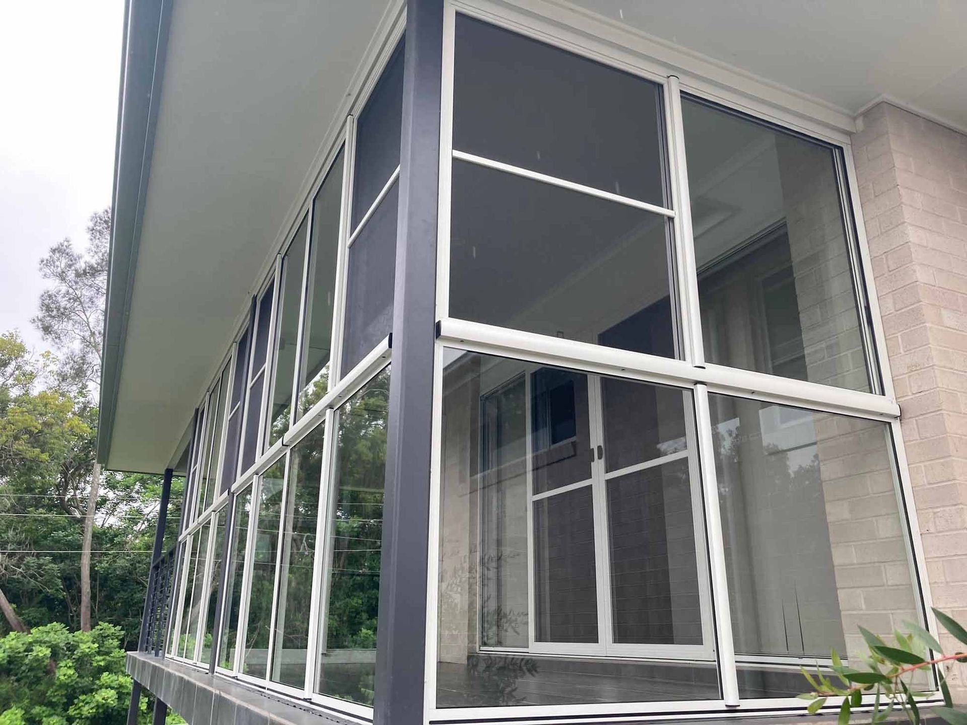 A house with a lot of windows and a screened in porch. — Patterson Glass Works in Kempsey, NSW
