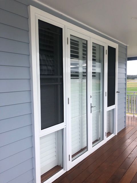 A Wooden Window and Door on White and Blue house— Patterson Glass Works in Kempsey, NSW