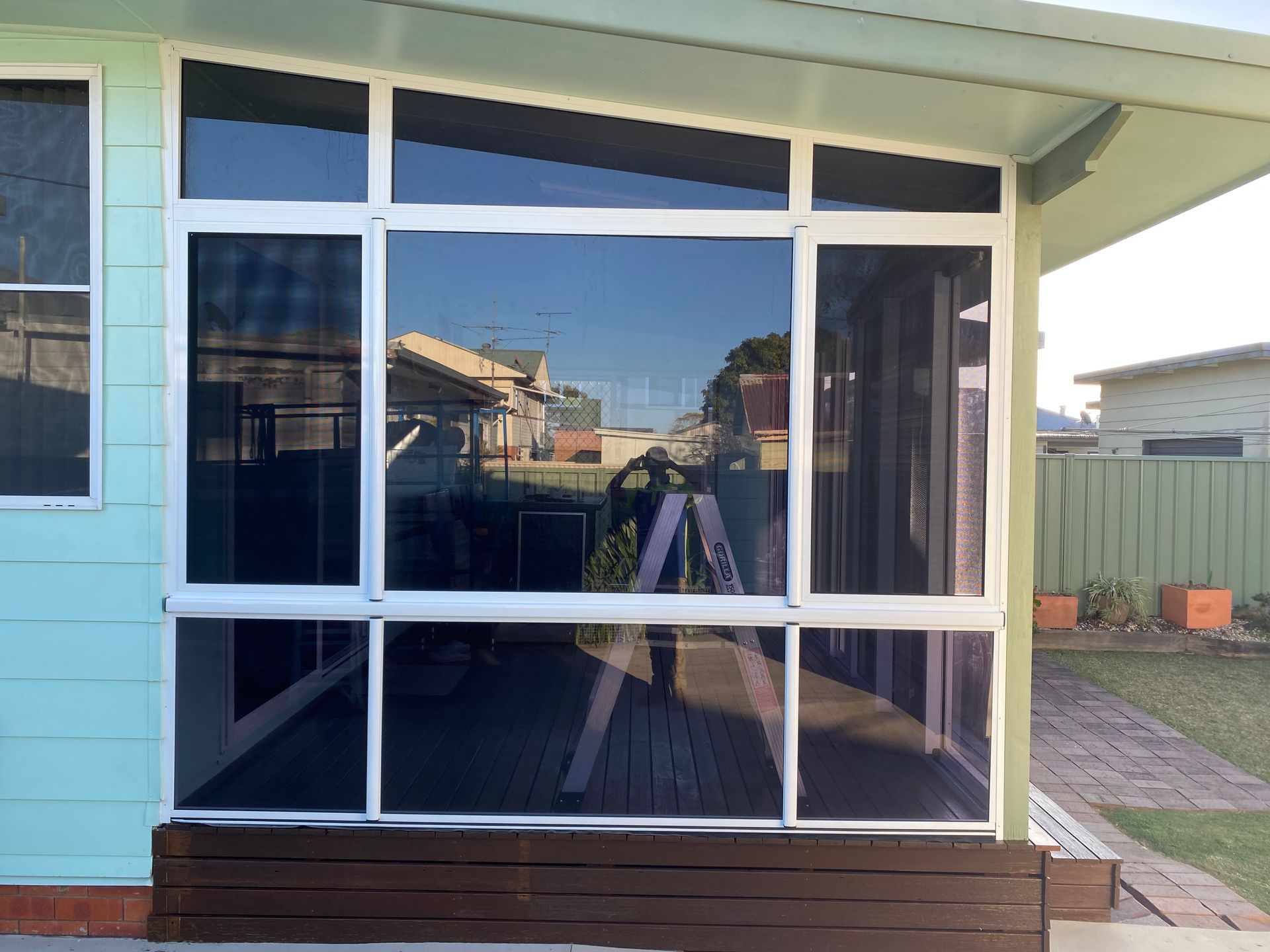 A House With A Screened In Porch And A Large Window — Patterson Glass Works in Frederickton, NSW