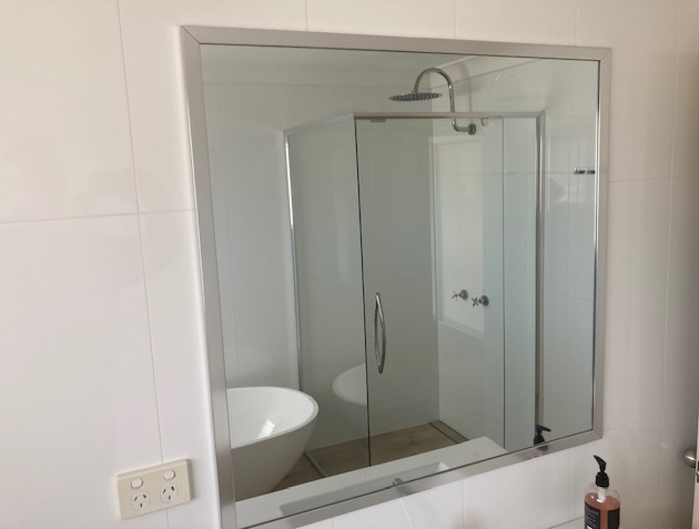 A Bathroom With a Large Mirror and a Window — Patterson Glass Works in Kempsey, NSW