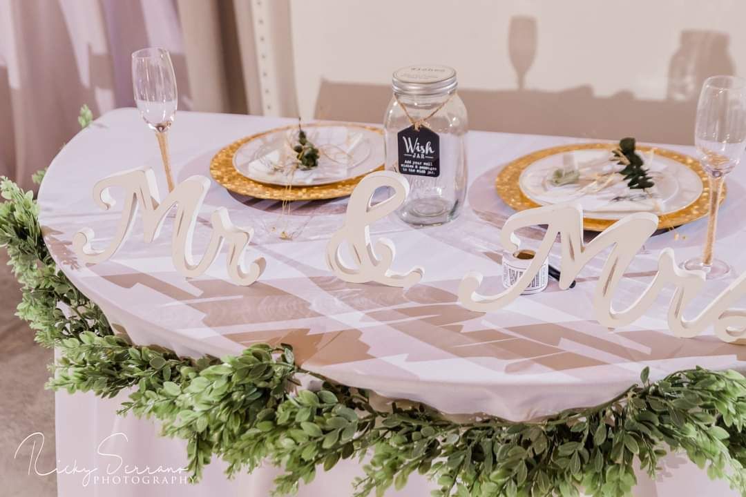 A large room with tables and chairs set up for a wedding reception.