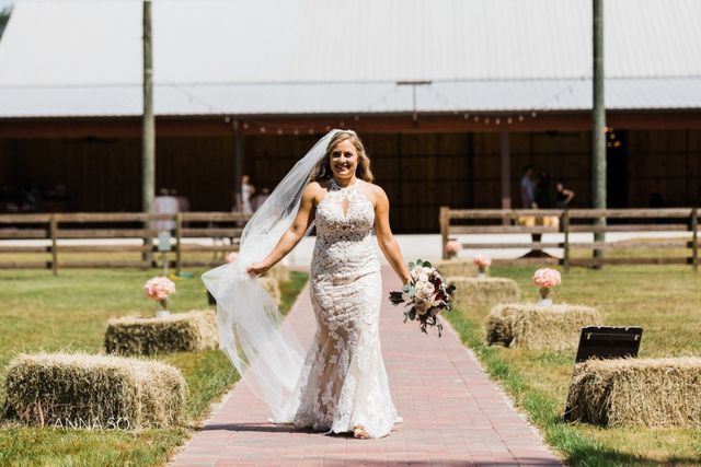 A bride in a wedding dress is walking down the aisle.