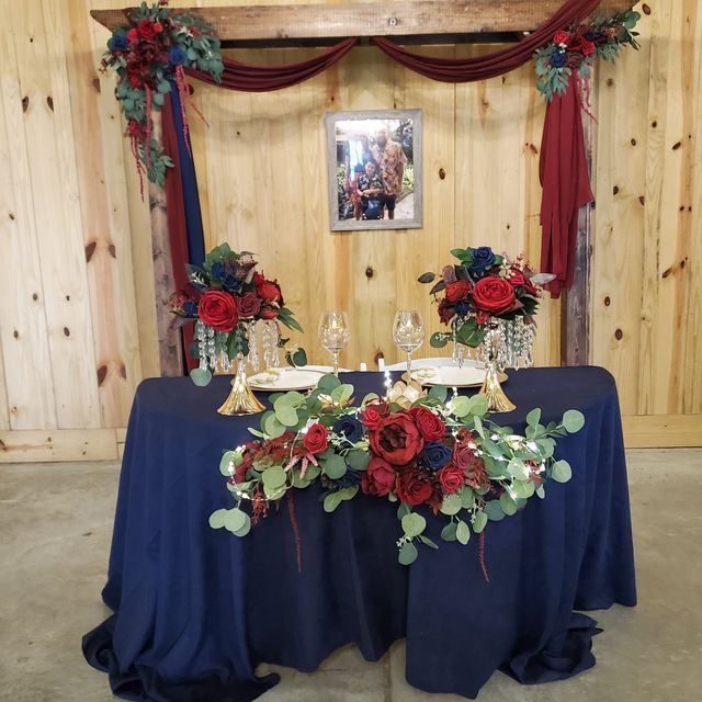 A table with a blue table cloth and flowers on it