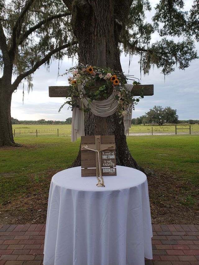 A table with a white table cloth and a cross on it