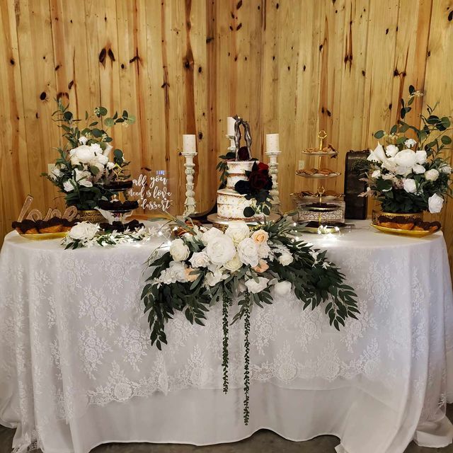 A table with a white table cloth and flowers on it