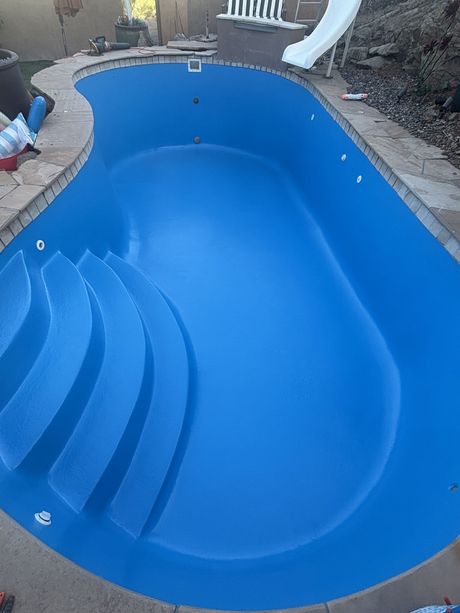Empty blue backyard swimming pool with new pool coating