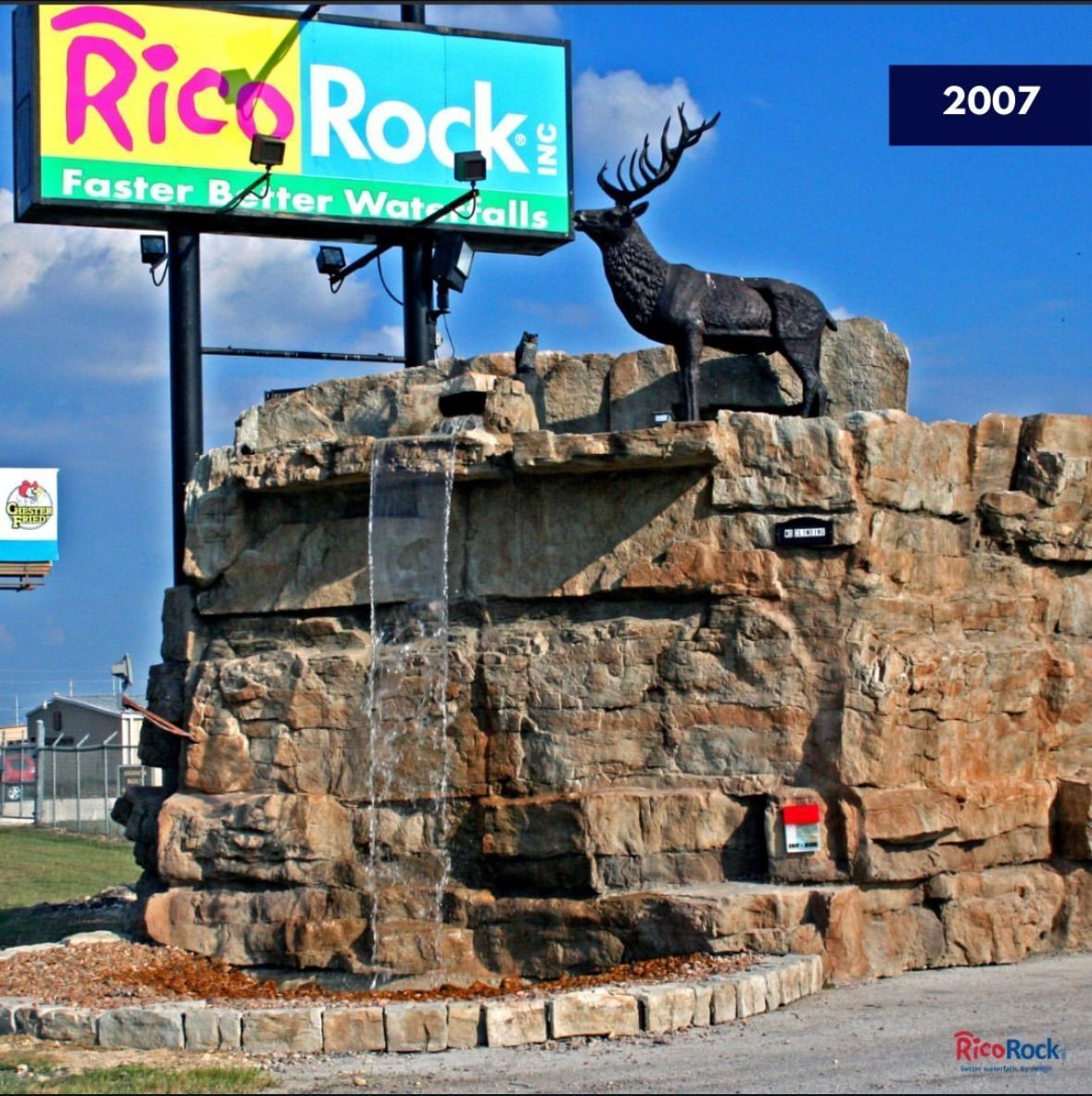 Rico Rock sign with artificial rock formation, waterfall, elk statue; 2007.