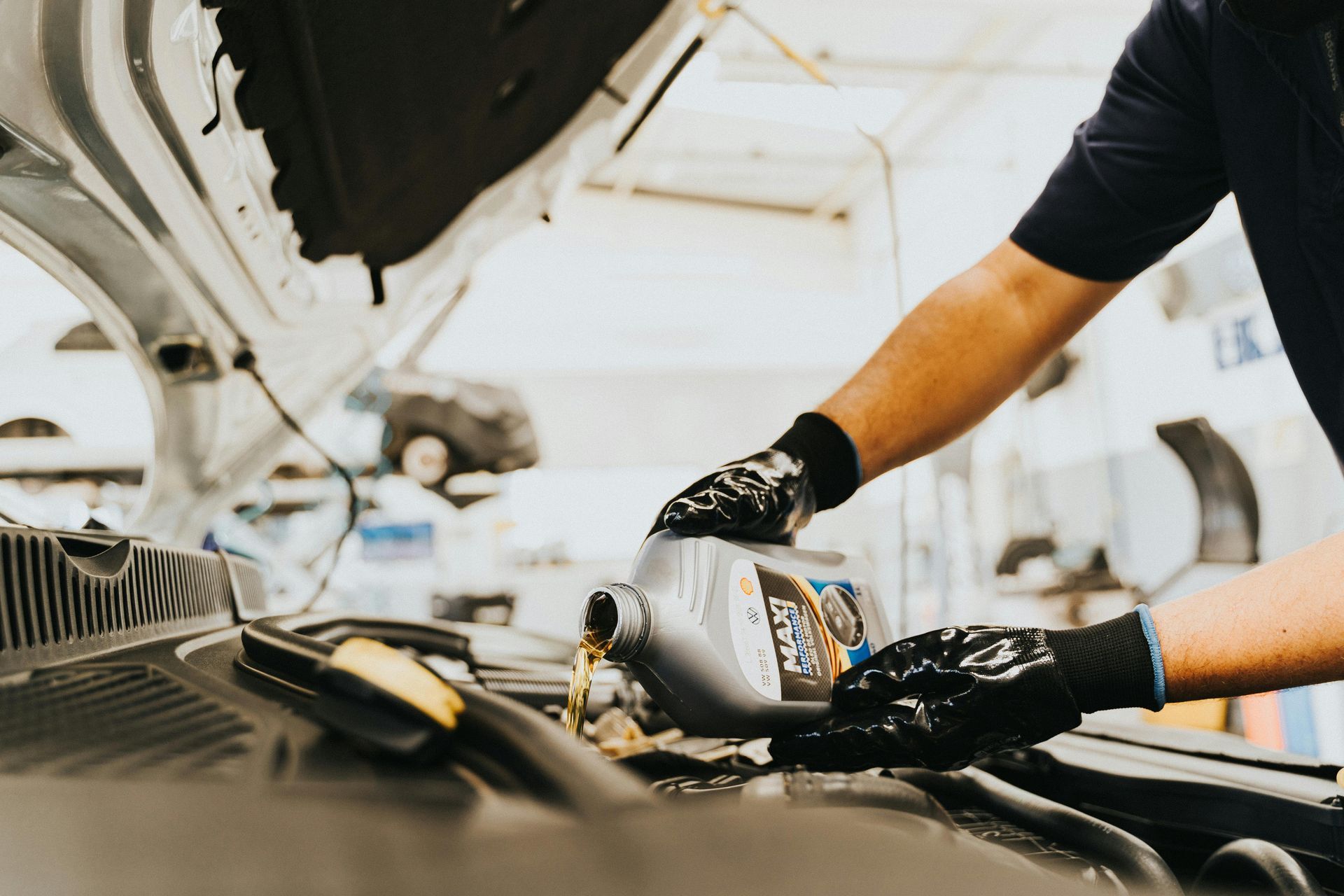 Mechanic Pouring Motor Oil During Engine Service | Total Automotive