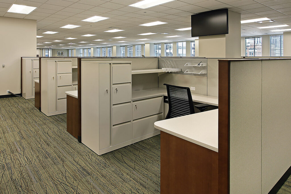 A row of cubicles in a large office building