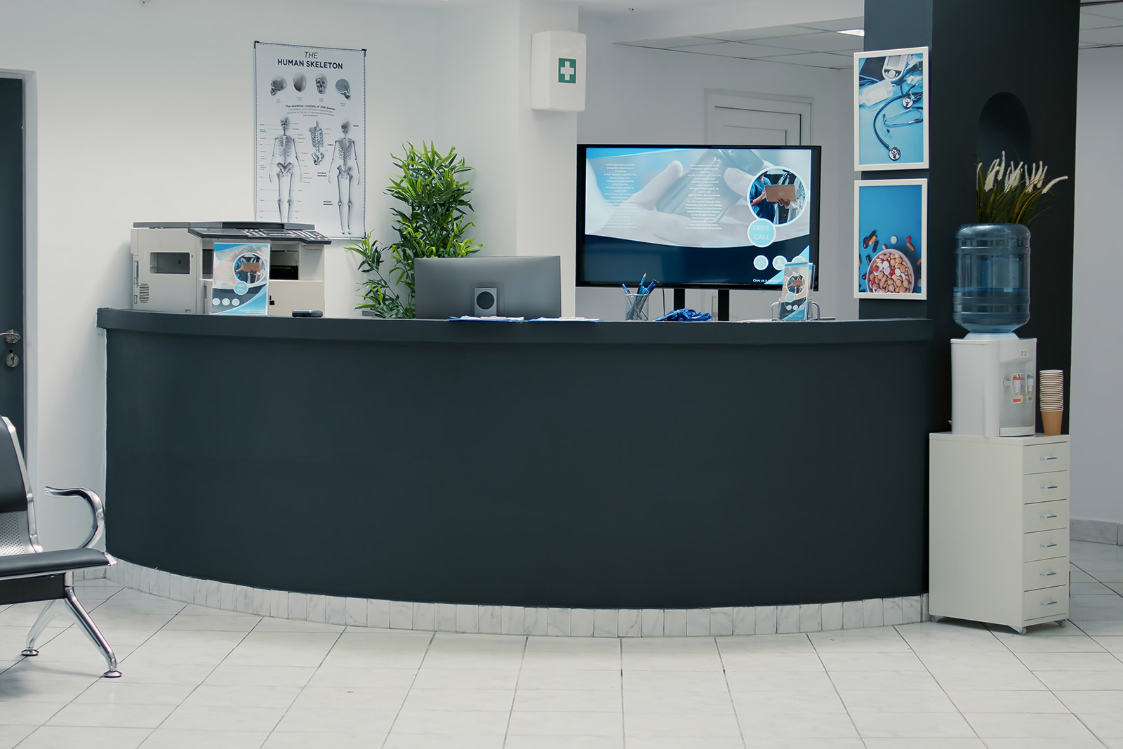 A waiting room with a black counter and a tv