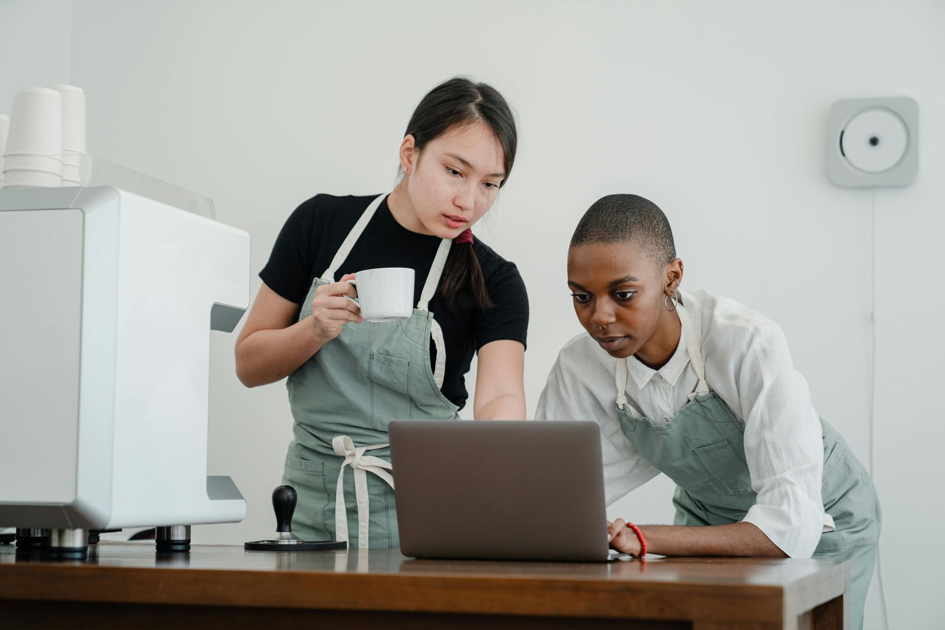 Red car with severe damage to the rear, loaded on a tow truck.