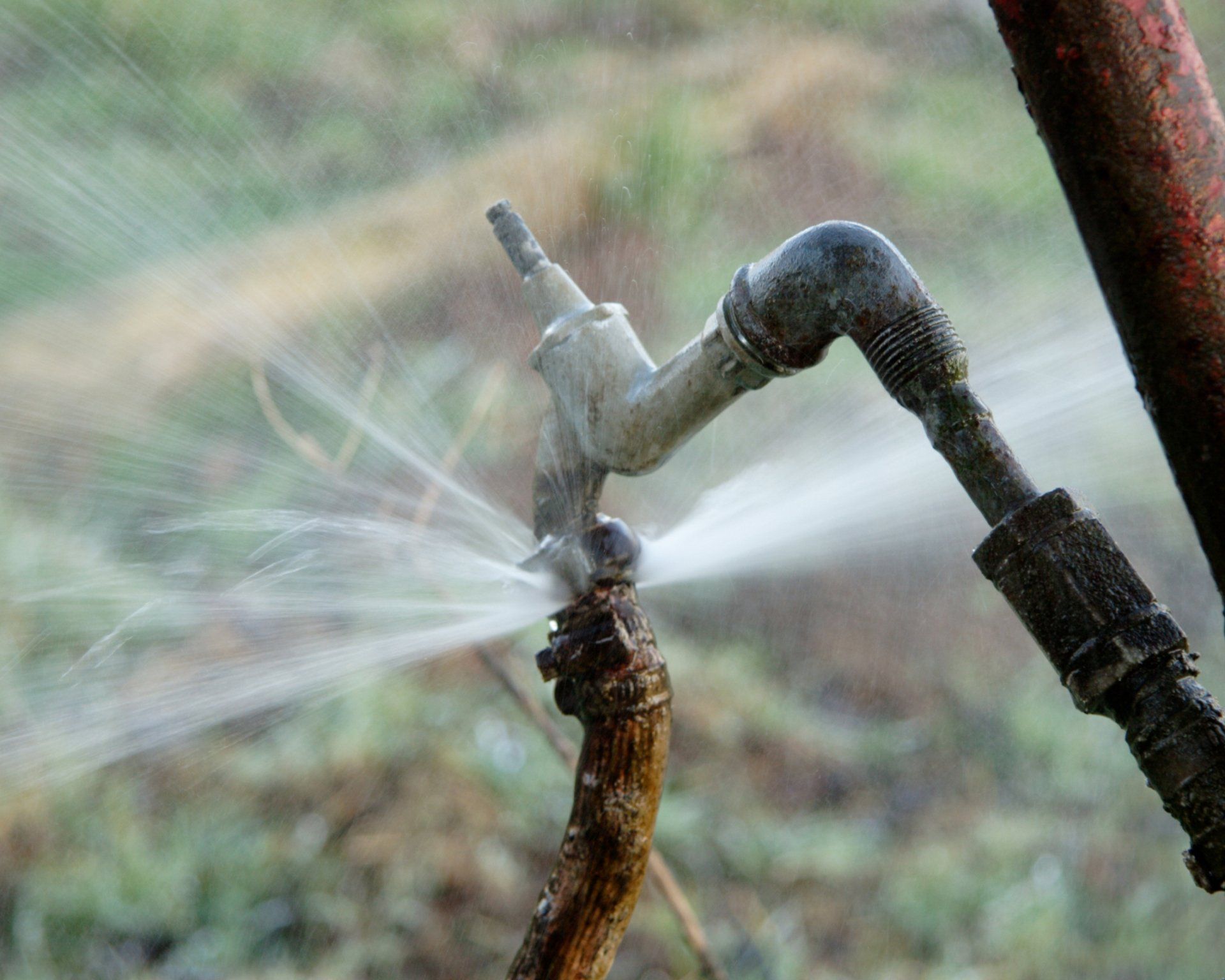 Water Gushing Faucet – Archdale, NC – Queen’s Septic Tank Service Spraying leaking pipes in need of emergency septic services in Kernersville, NC