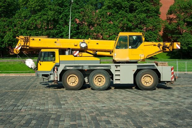a yellow portable crane truck