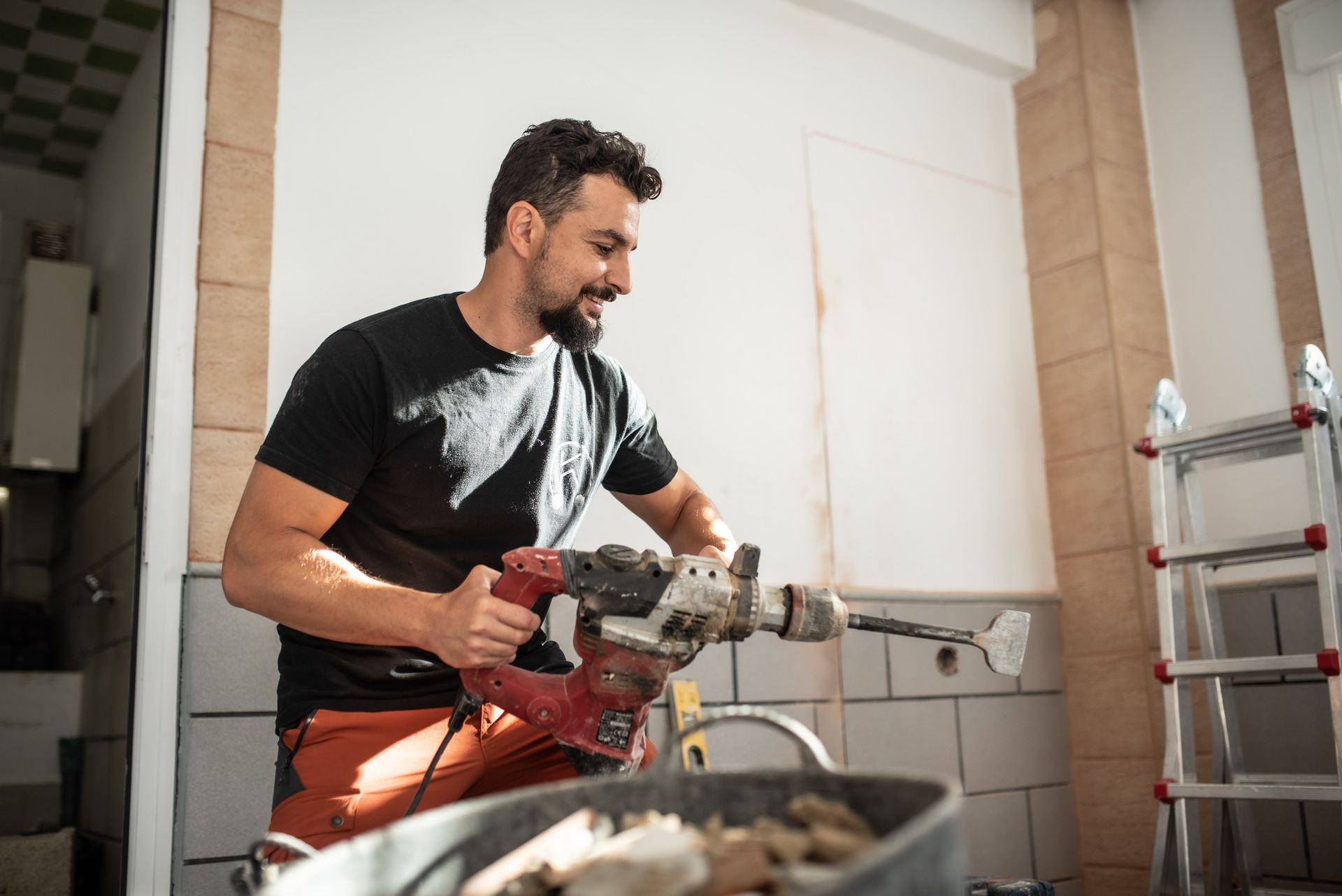 A man is working on a bathroom remodel.