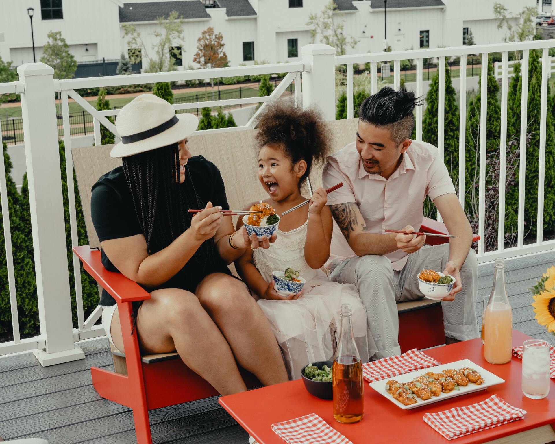 Family of 3 enjoying a meal outside