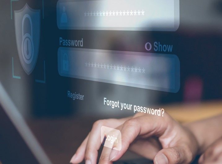 a person is typing a password on a laptop computer